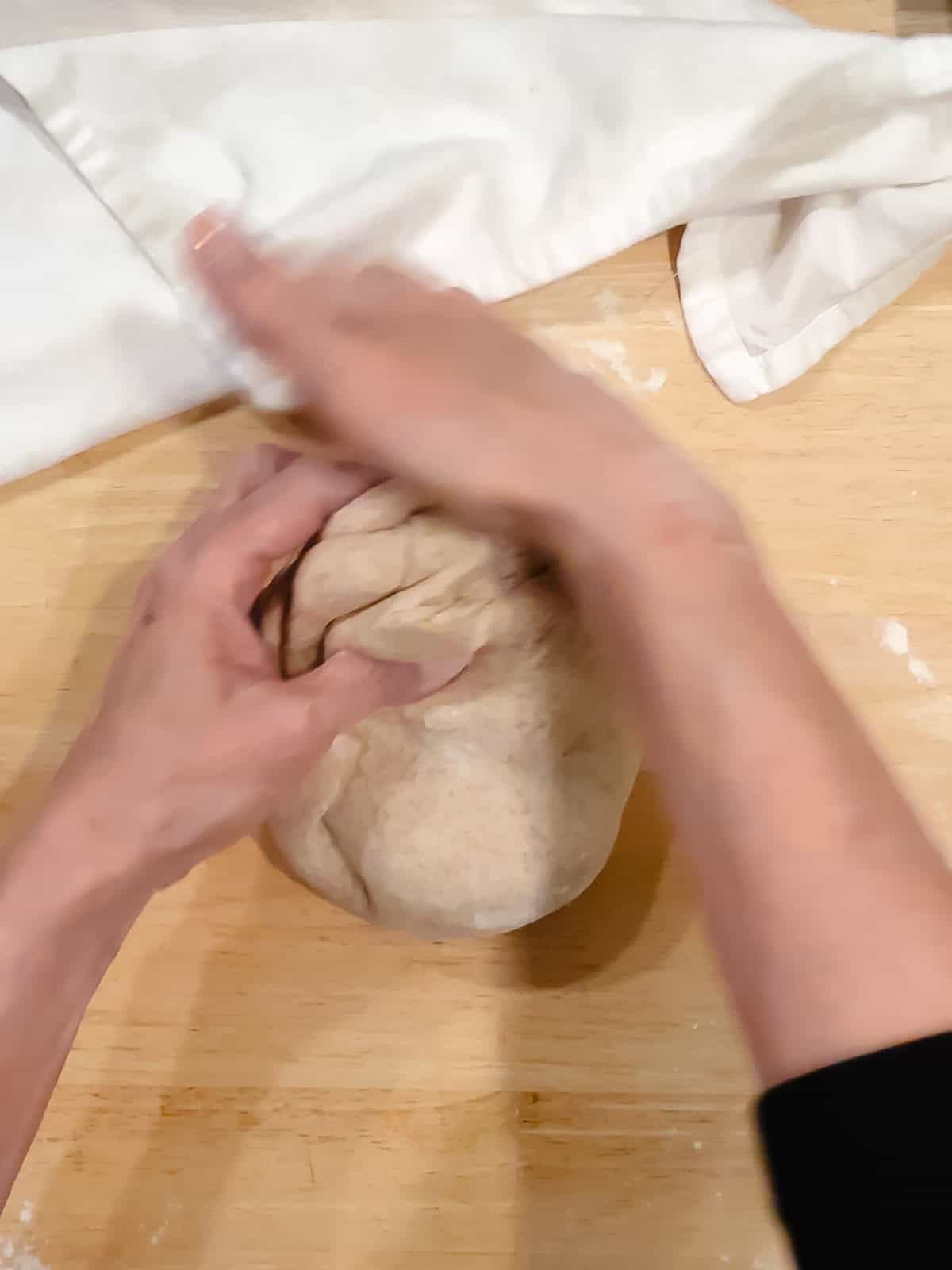 Hand kneading honey whole wheat dough.