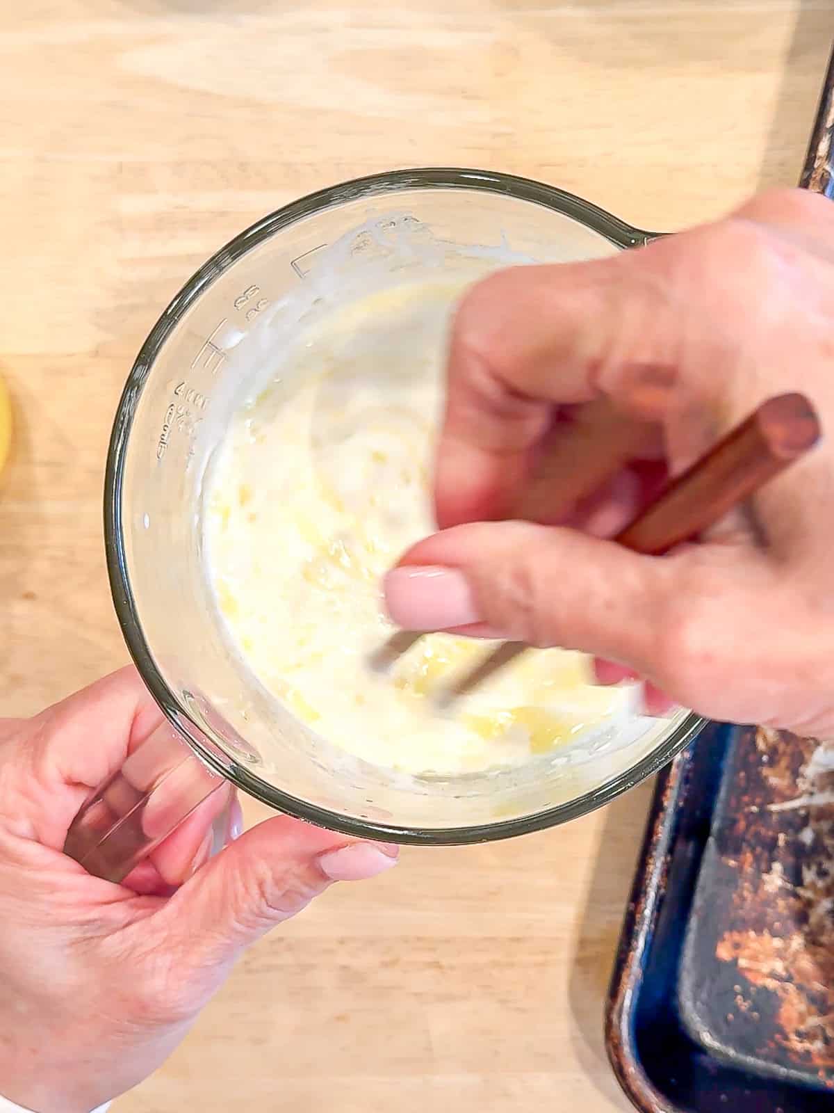 Mixing wet ingredients for waffle batter.