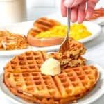 Waffle house waffle waffles on a white plate with more breakfast in the background.