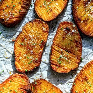 Crispy accordion potatoes on parchment paper.