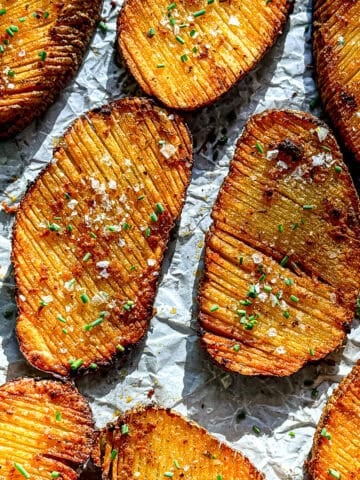 Crispy accordion potatoes on parchment paper.