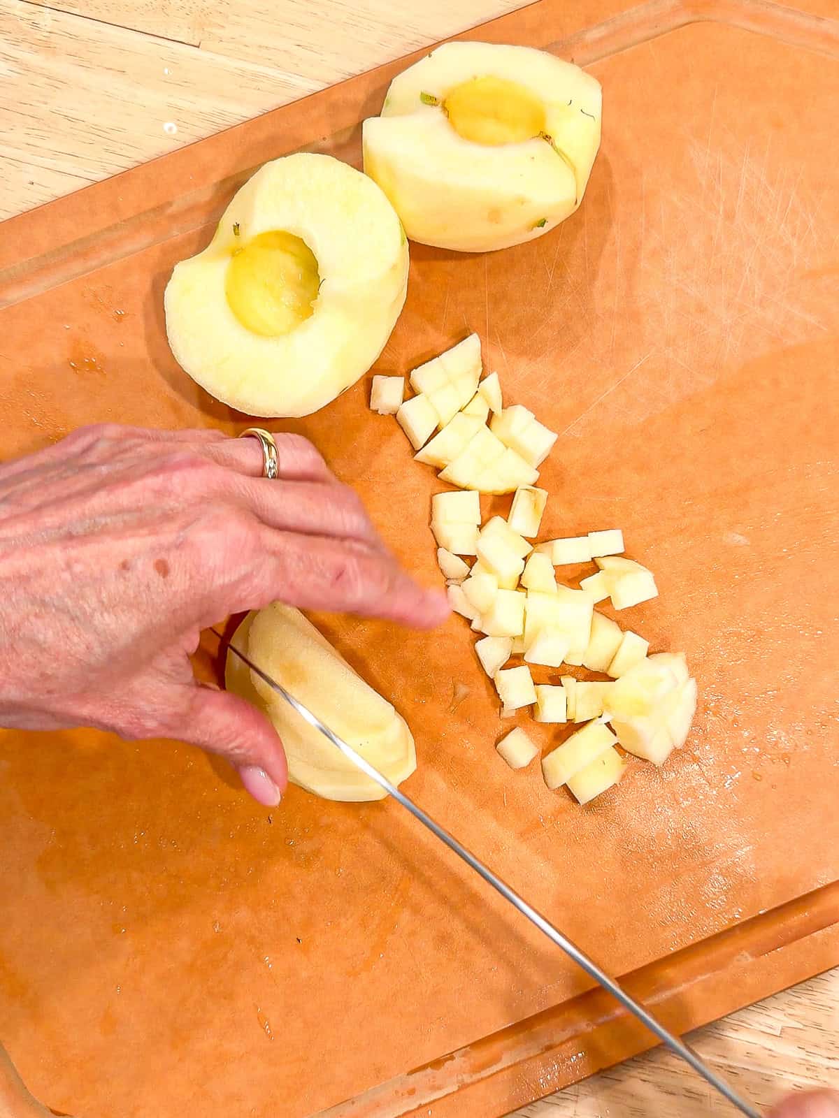 Cutting apples into ¼ inch dice.