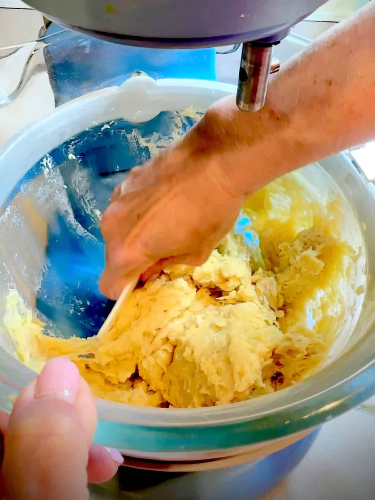 Scraping the side of the stand mixer bowl before putting on dough hook.