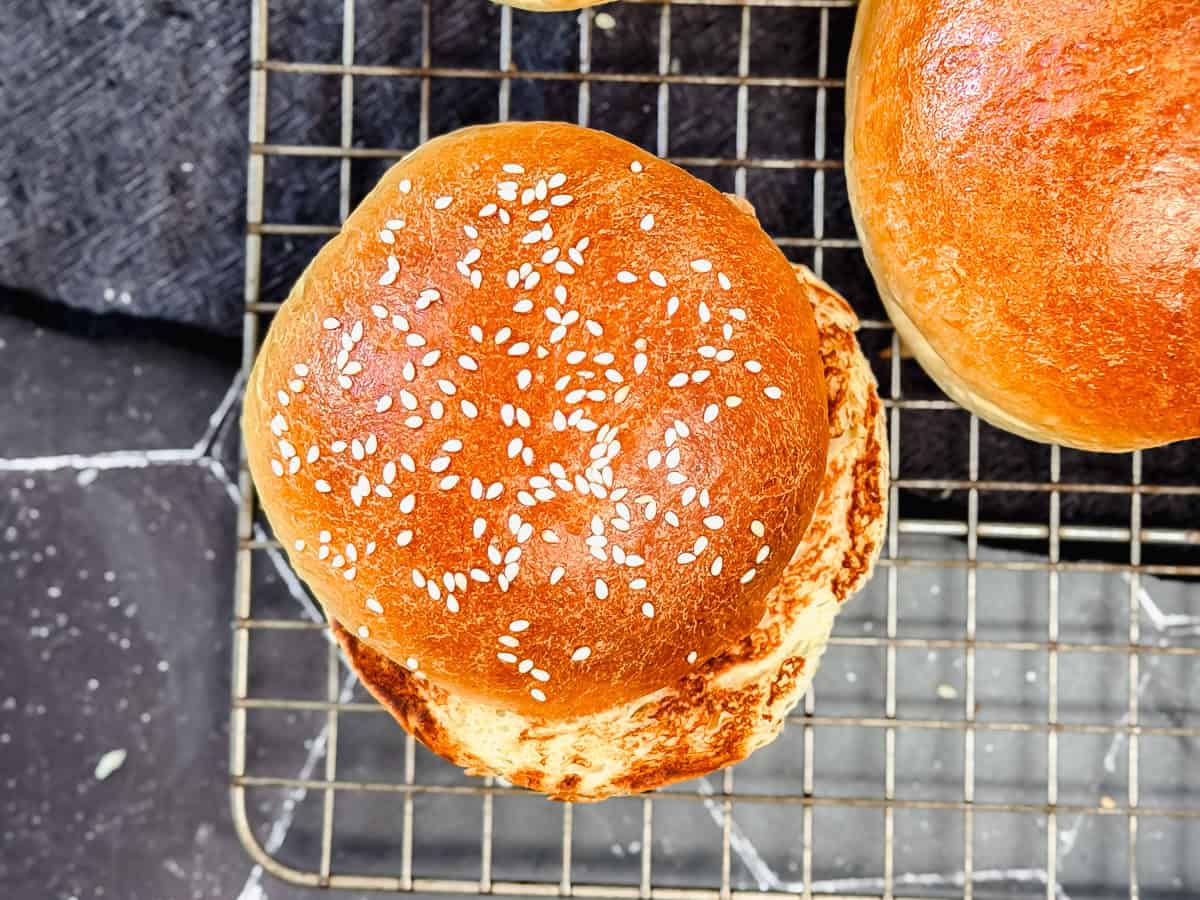 Toasted brioche bun on a wire rack.