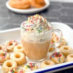 Glazed donut latte with whipped cream and sprinkles.