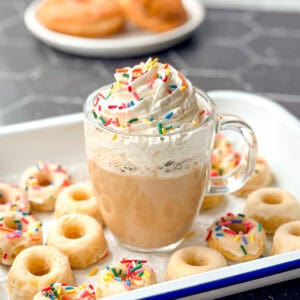 Glazed donut latte with whipped cream and sprinkles.