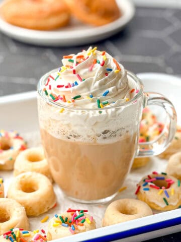 Glazed donut latte with whipped cream and sprinkles.