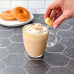 Garnishing donut latte with a mini donut.