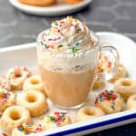Glazed donut latte with whipped cream and sprinkles.
