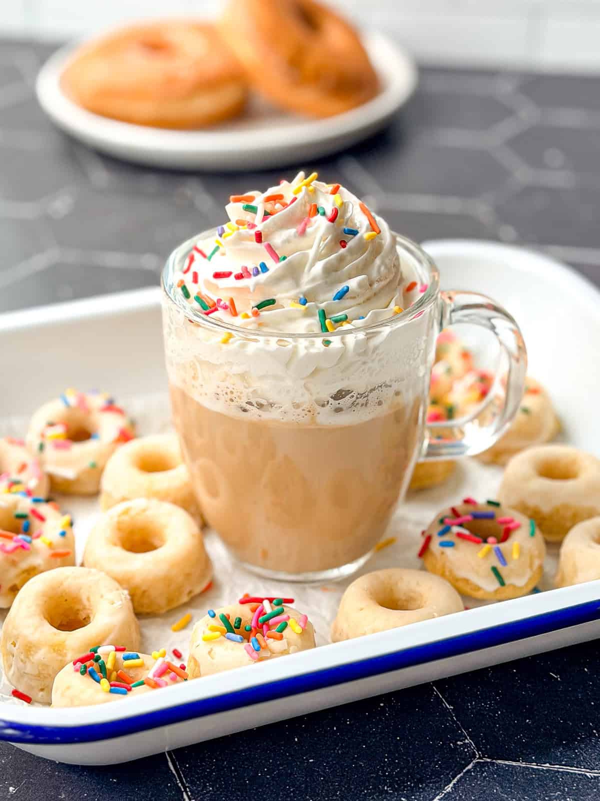 Glazed donut latte with whipped cream and sprinkles.