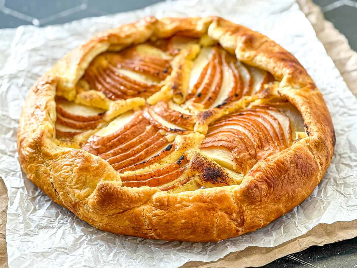 Pear galette on parchment paper.