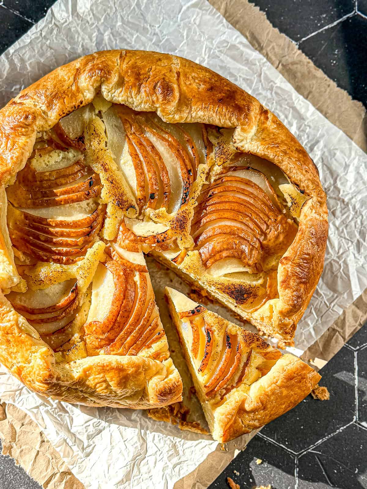 Pear galette on parchment paper.