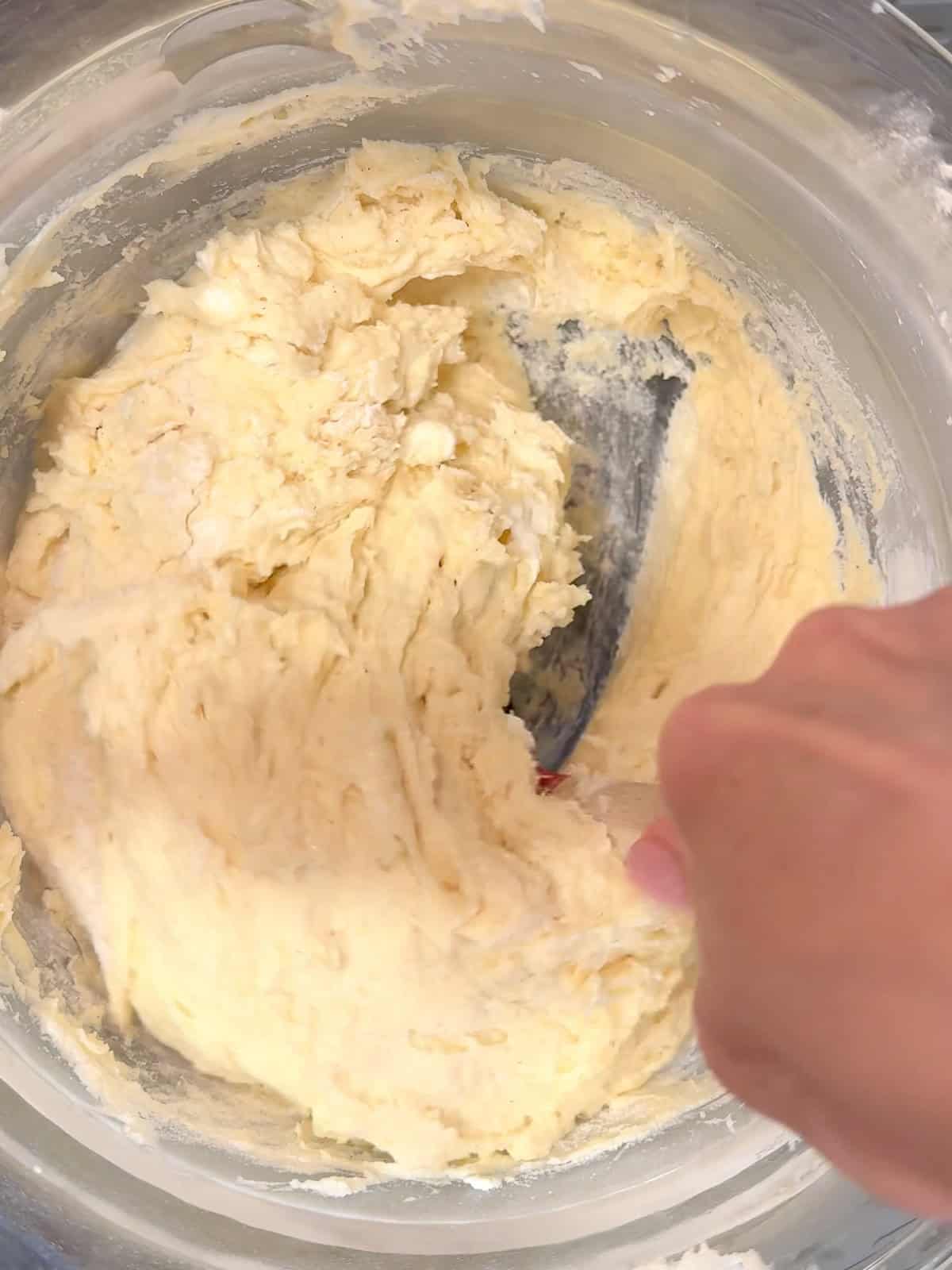 Mixing pound cake batter by hand.