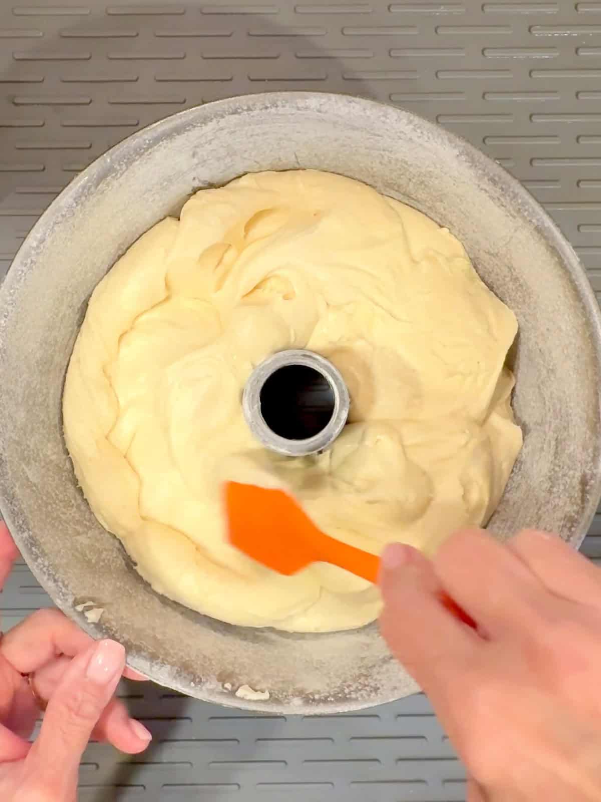Spreading poundcake batter into a tub pan.