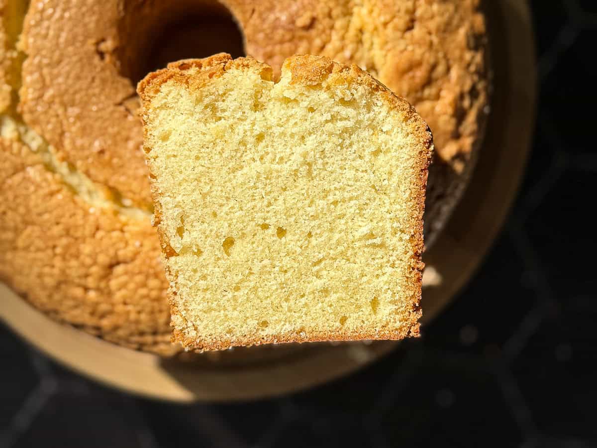 Sliced pound cake on a cake stand.