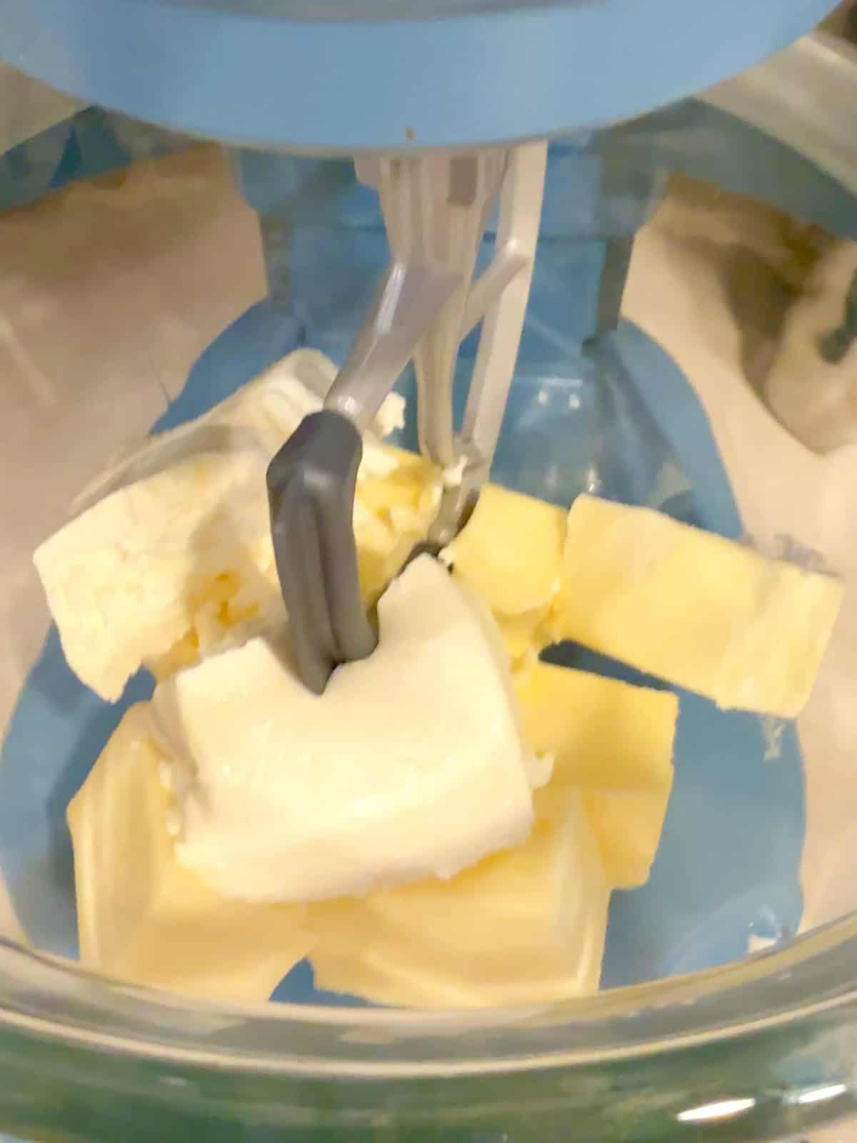Mixing cream cheese and softened butter in a standard mixer.