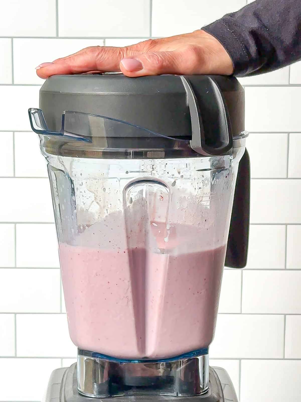 Blending a strawberry banana smoothie.