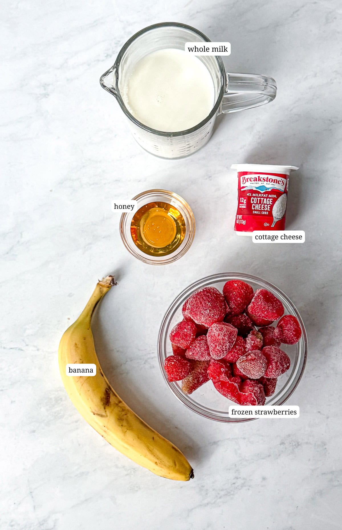 Image of ingredients needed to make a strawberry banana smoothie.
