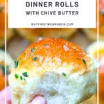 Pinterest image of a hand holding a dinner roll with chive butter.