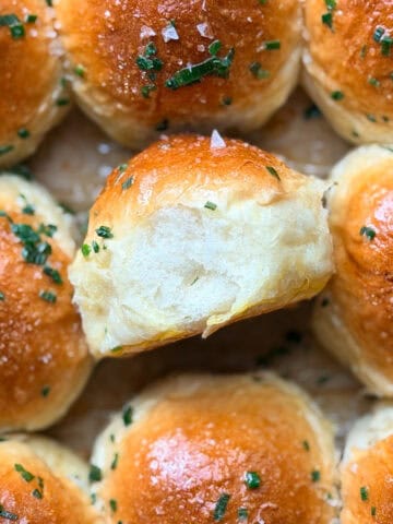 Dinner rolls with chive butter and flaky salt.