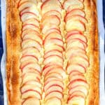 Apple frangipane tart on parchment paper.