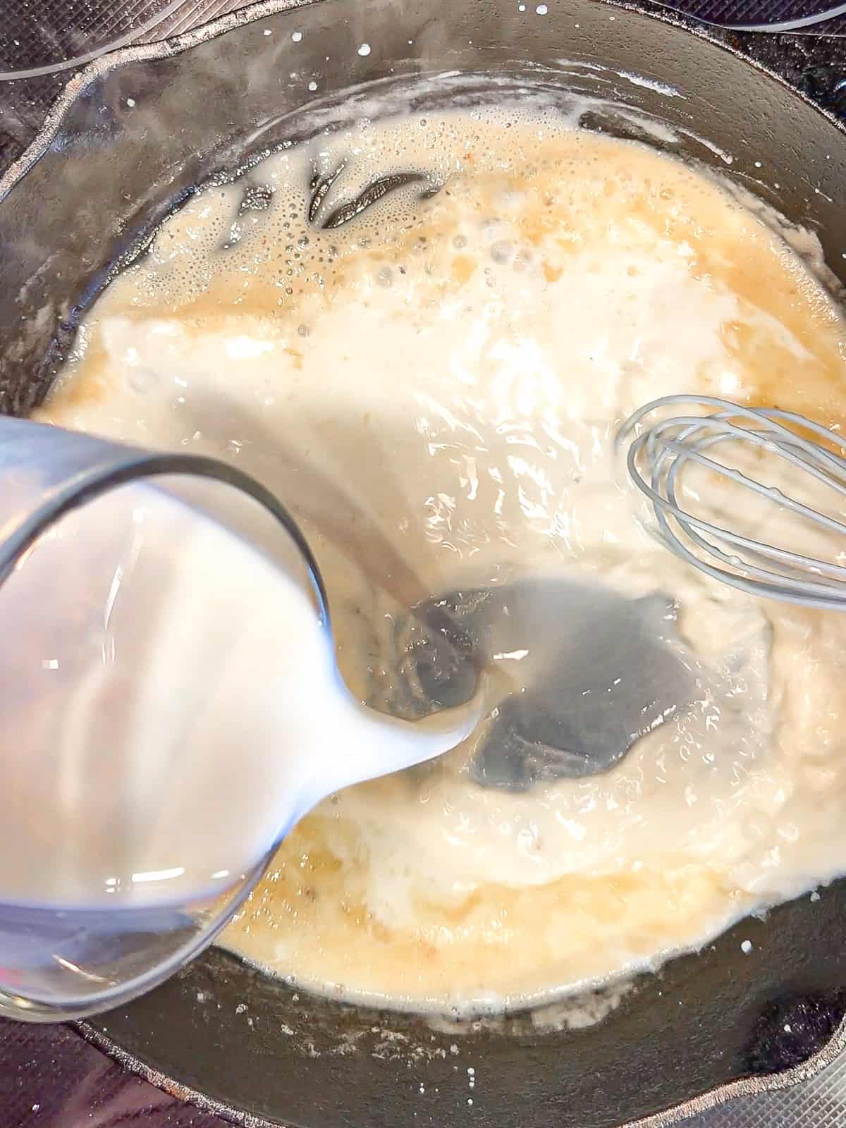 Pouring milk to make gravy.