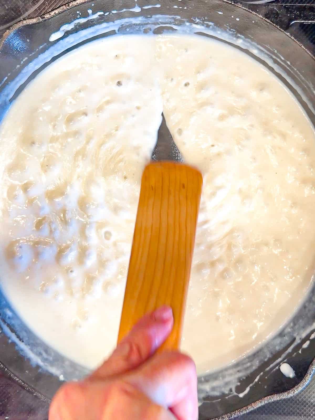 Dragging a spatula through gravy to show the thickness.