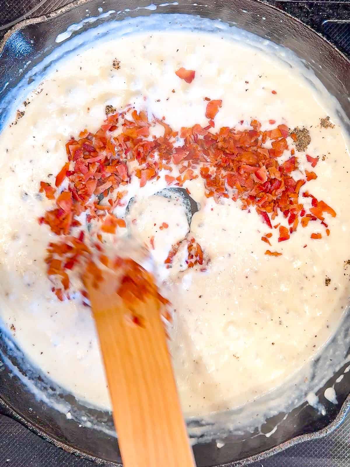 Stirring bacon into gravy.