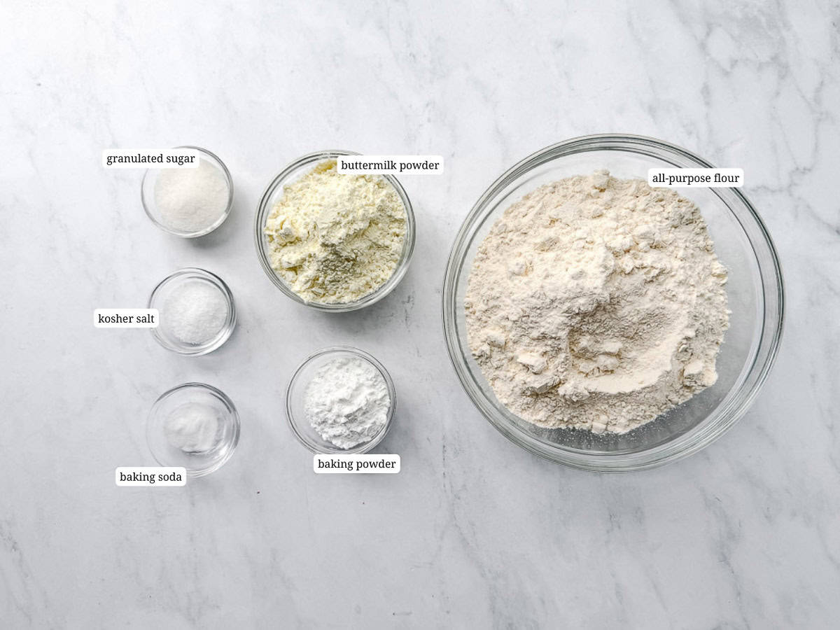 Dry ingredients for biscuit mix on a white counter.