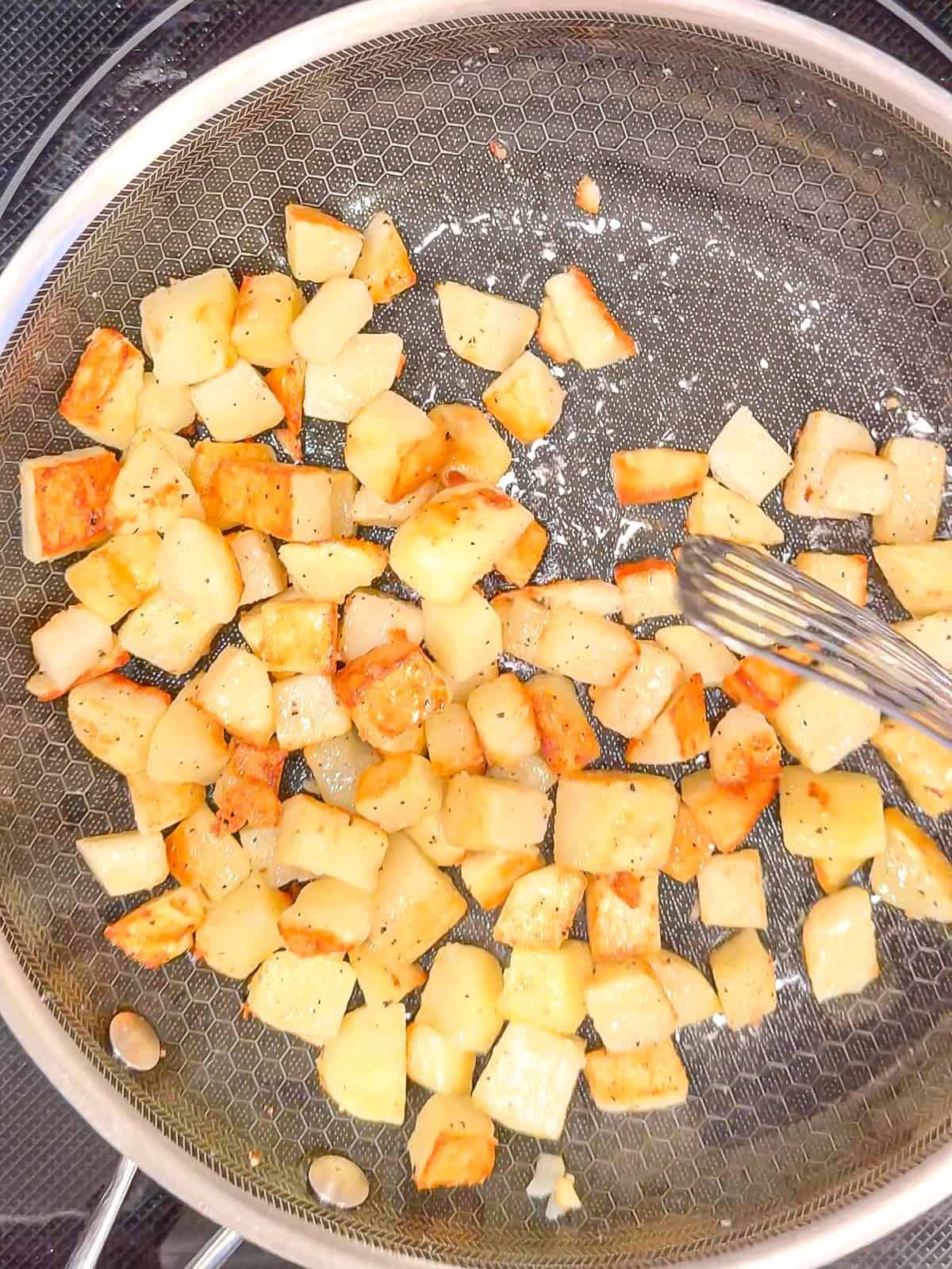 Roasting potatoes in a pan.