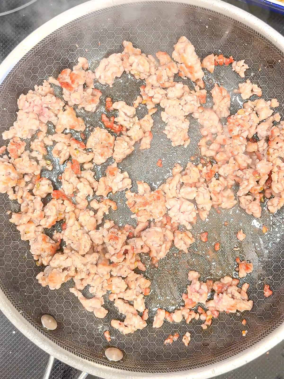 Cooking breakfast sausage in a pan.