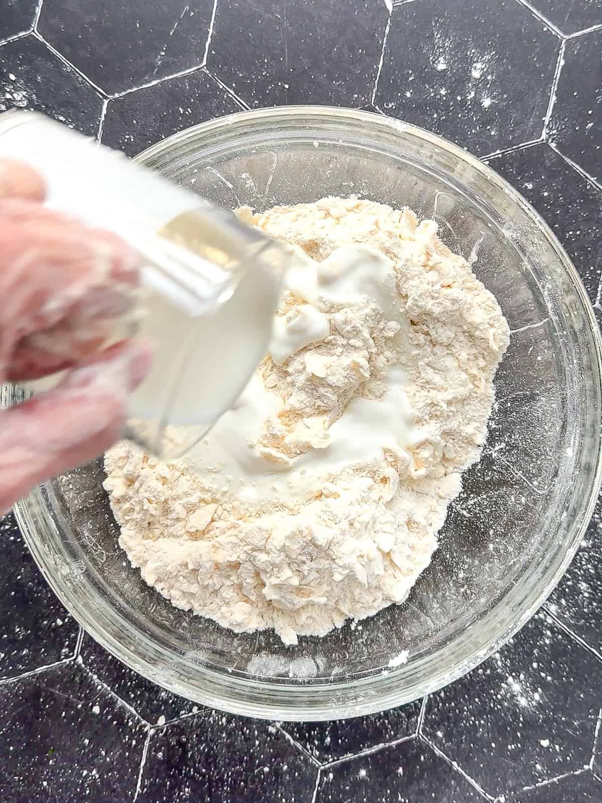 Adding buttermilk to flour and butter mixture.