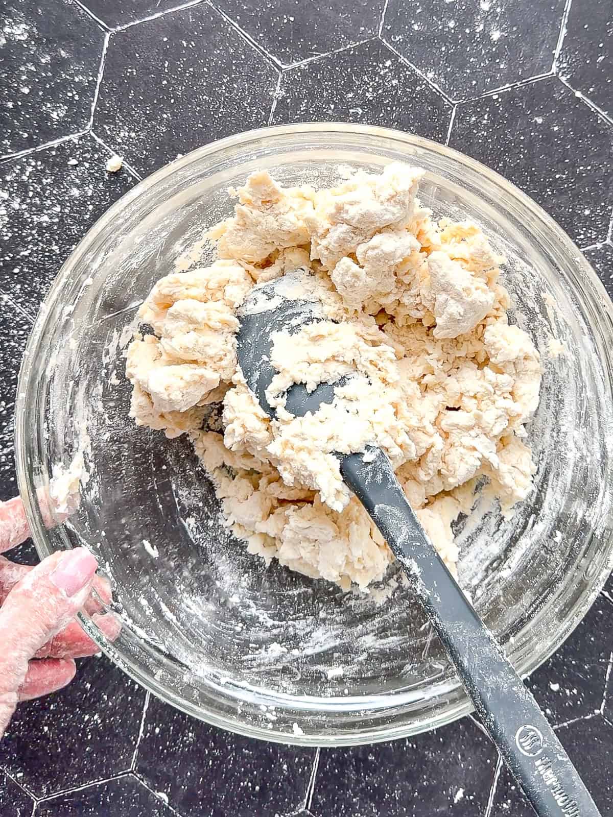 Mixed biscuit dough in a glass bowl.