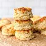 Stack of Gruyere biscuits on parchment paper.