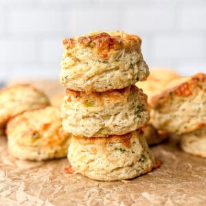 Stack of Gruyere biscuits on parchment paper.