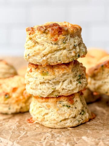 Stack of Gruyere biscuits on parchment paper.