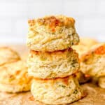 Stack of Gruyere biscuits on parchment paper.