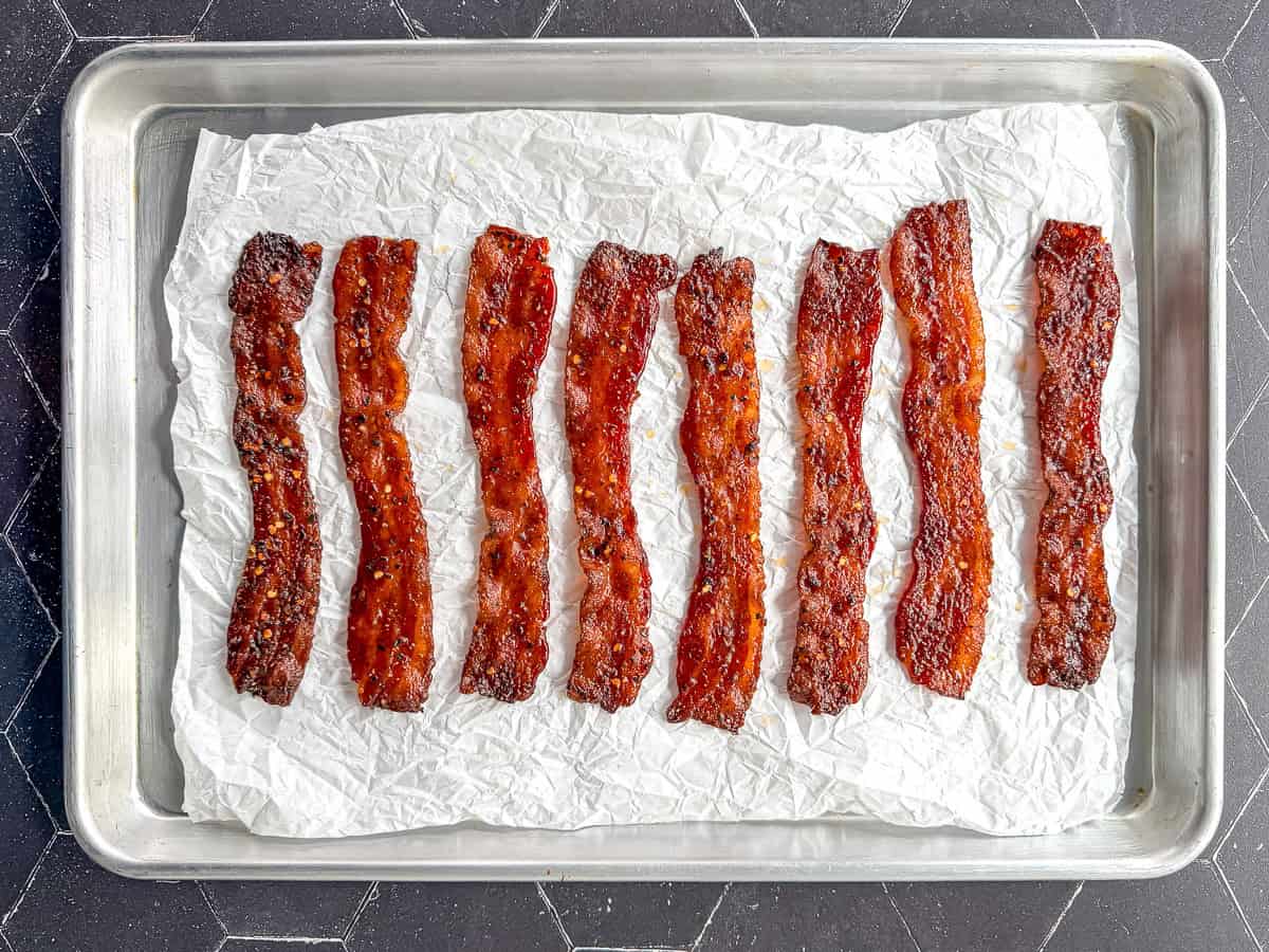 Millionaire bacon on a parchment paper cpvered sheet pan.