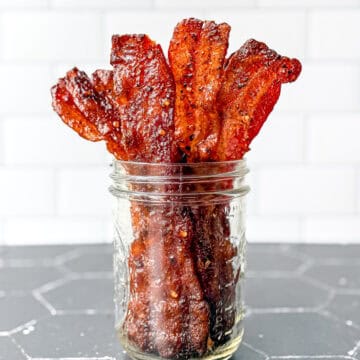 millionaire bacon standing up in a mason jar.
