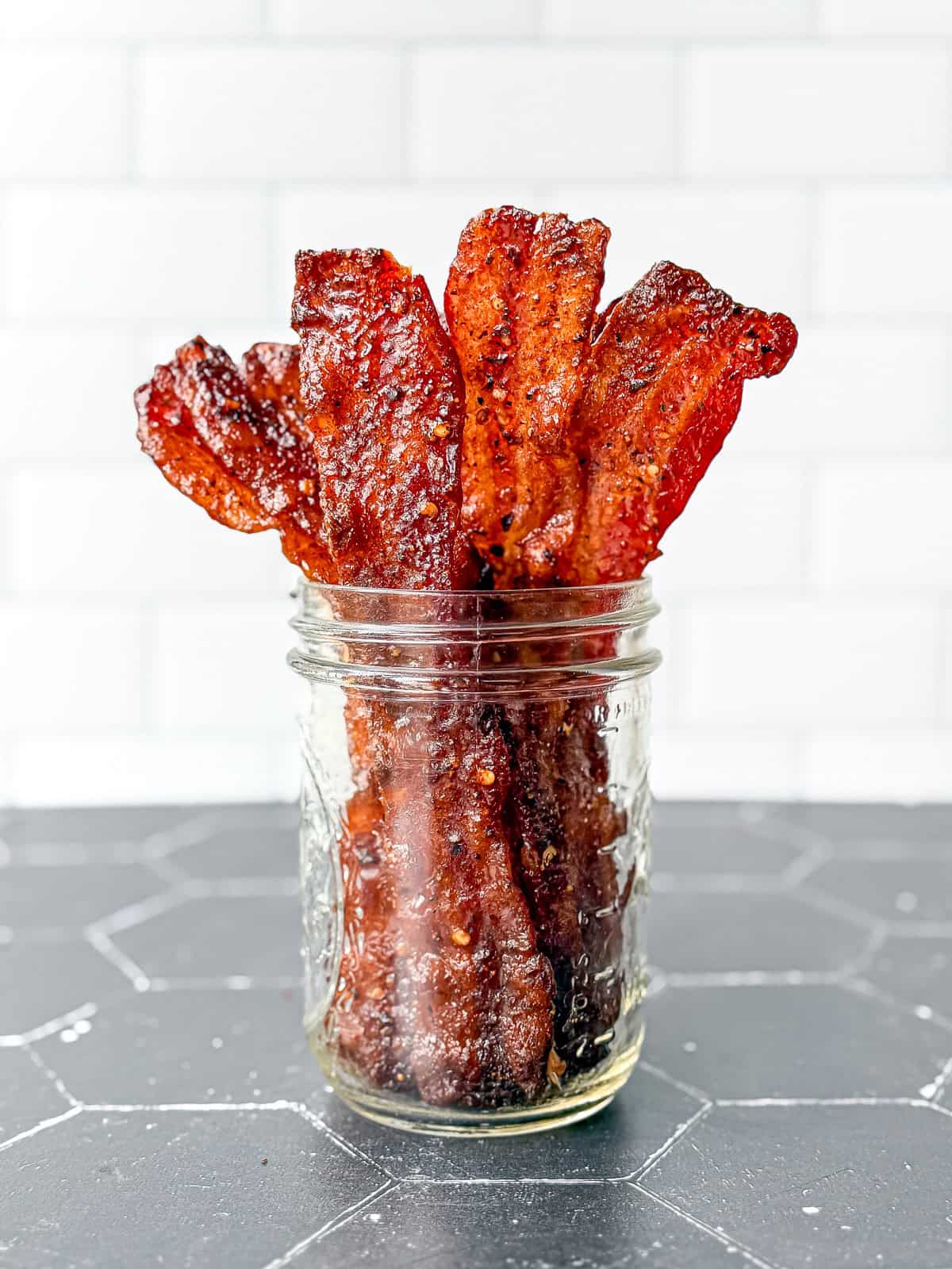 millionaire bacon standing up in a mason jar.