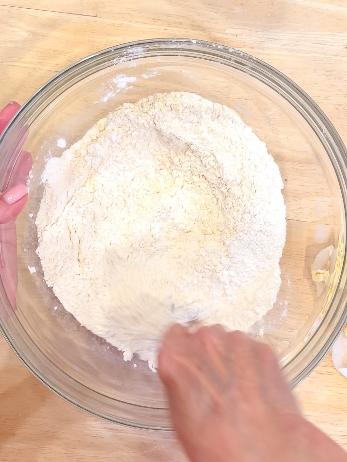 Mixing dry ingredients in a glass bowl.