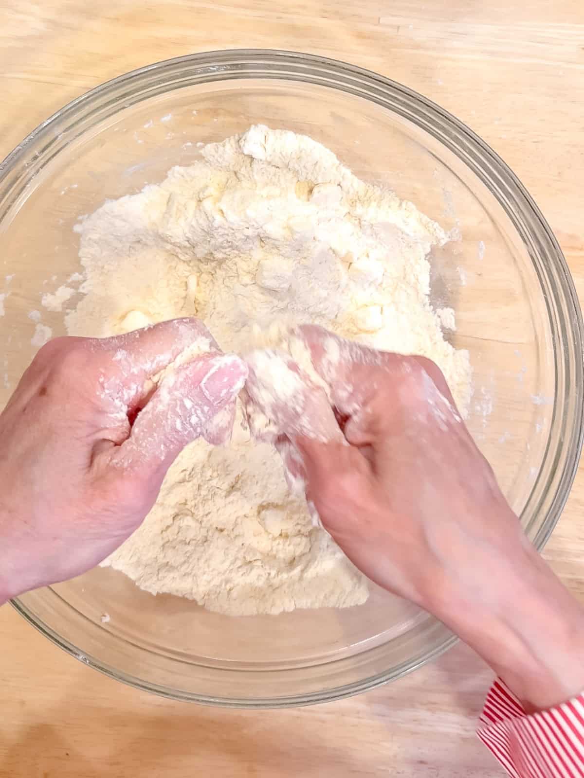 Cutting butter into dry ingredients to make scones.