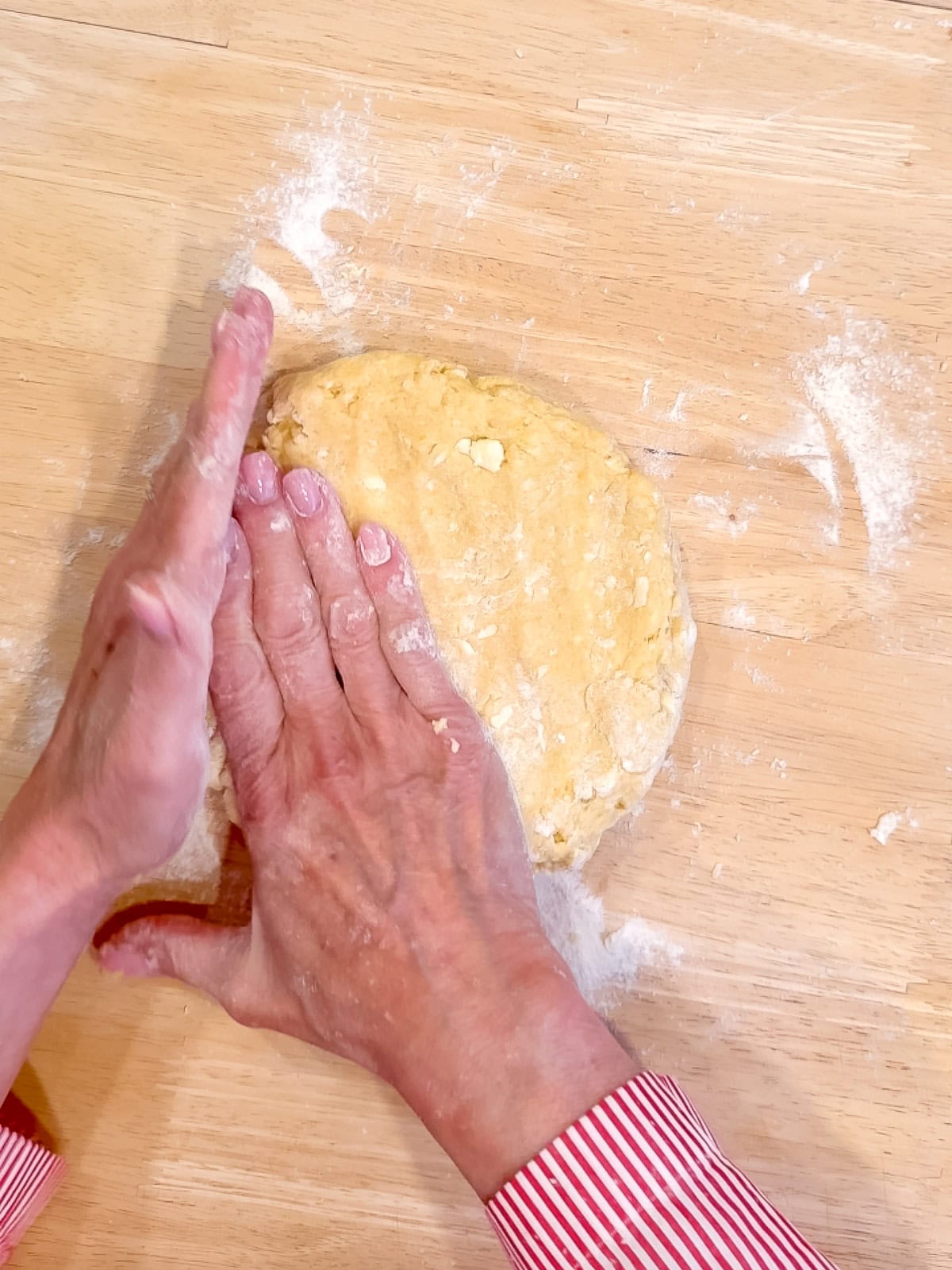Shaping scone dough into a disc.