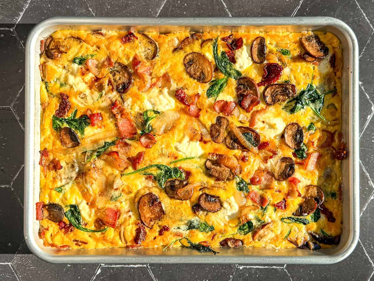 Frittata in a sheet pan on a black counter.