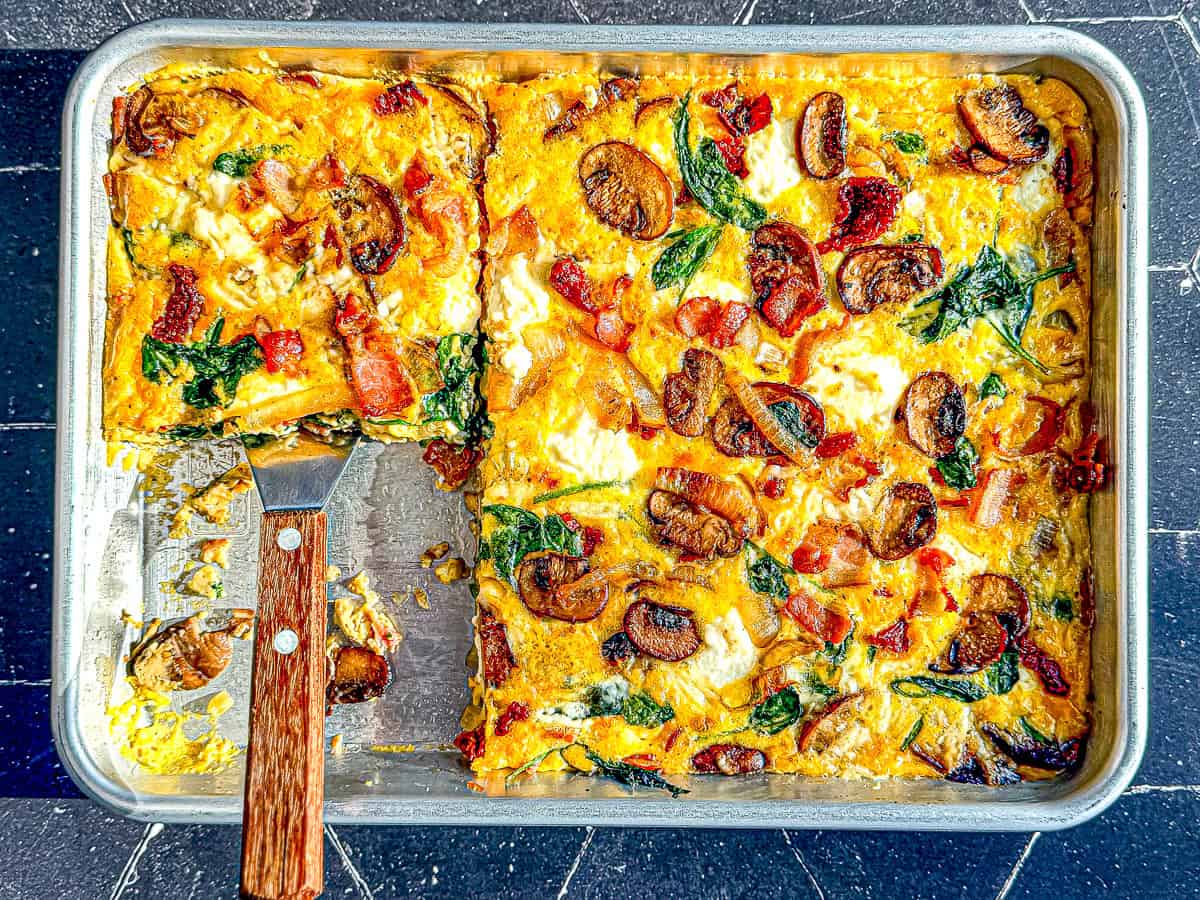 Frittata on a sheet pan with spatula.