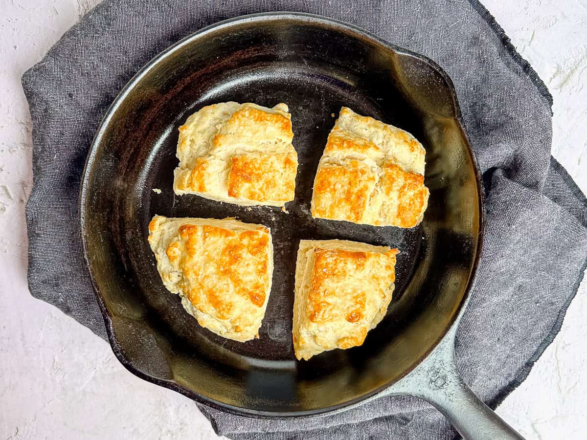 Four square-Ish biscuits in a cast-iron pan.