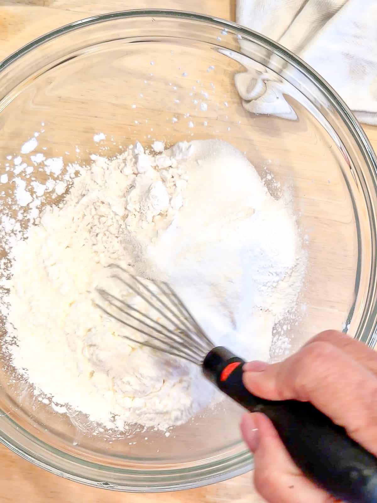Whisking dry ingredients to make waffle batter.