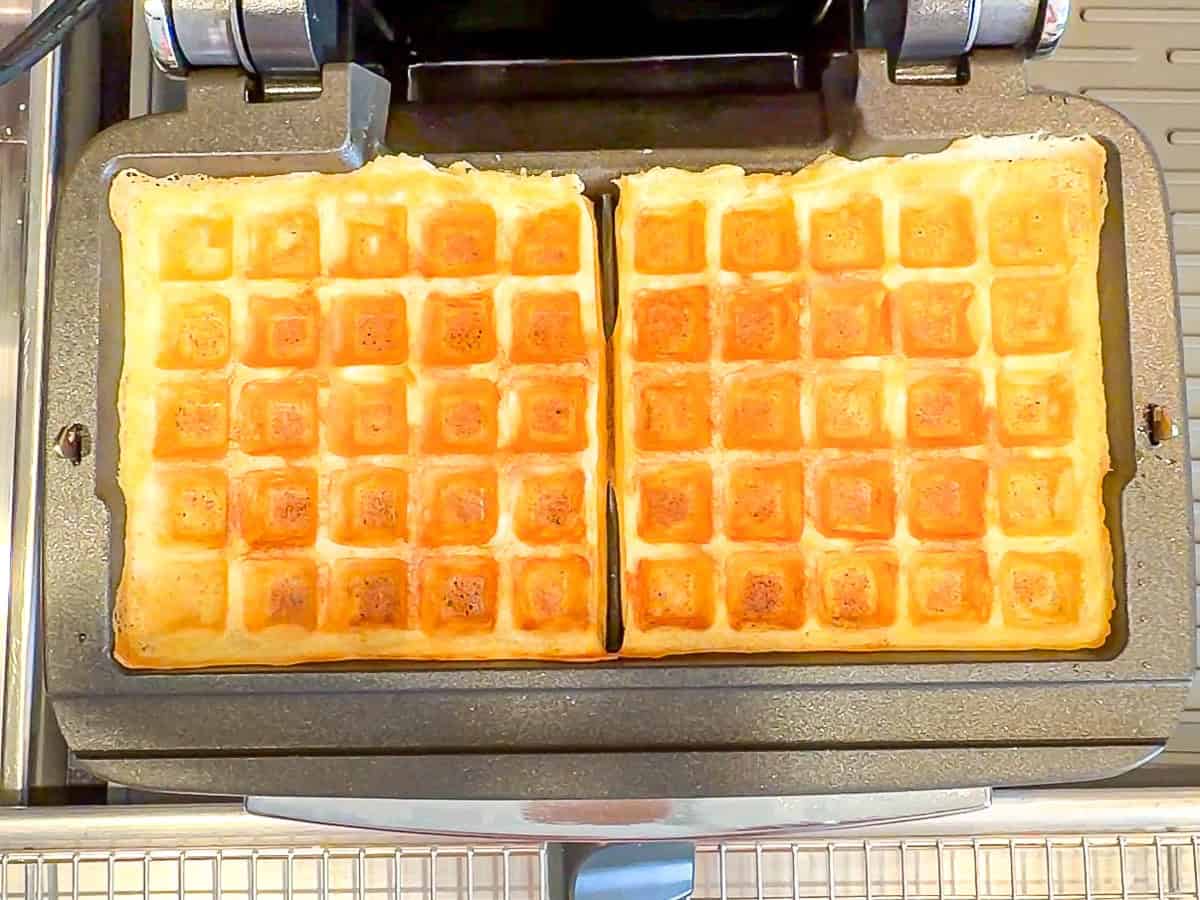 Cooked waffles in a waffle iron.