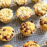 Various flavors of muffins on a wire rack.