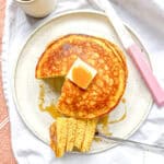 Eggnog pancakes on a white plate.